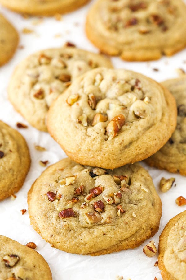 Close up of two Butter Pecan Cookies on white paper