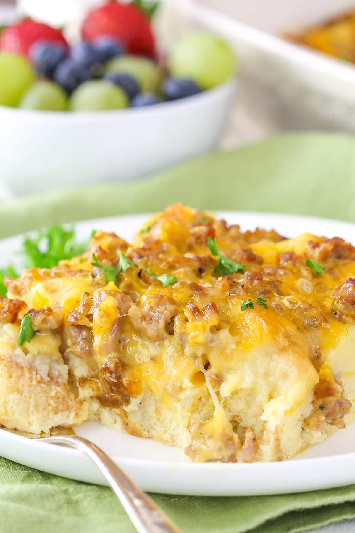A slice of overnight breakfast casserole on a white plate