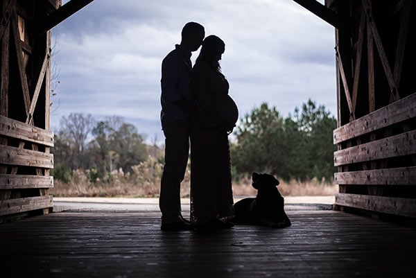 Twins & Pregnancy Update A Silhouette of me, my Husband and our Dog in a Covered Bridge