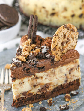 A slice of Oreo brookie cheesecake on a plate with a fork.