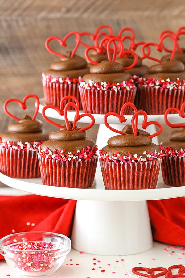 Red Velvet Cupcakes with Chocolate Cream Cheese Frosting displayed on white stands