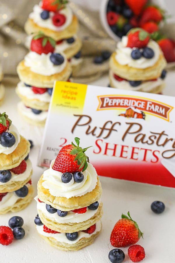 Berries and Cream Mini Puff Pastry Cakes and puff pastry sheets in background
