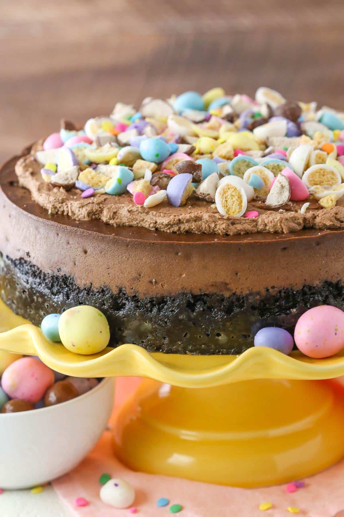 Close up of an Easter chocolate cheesecake topped with crushed malted eggs. 