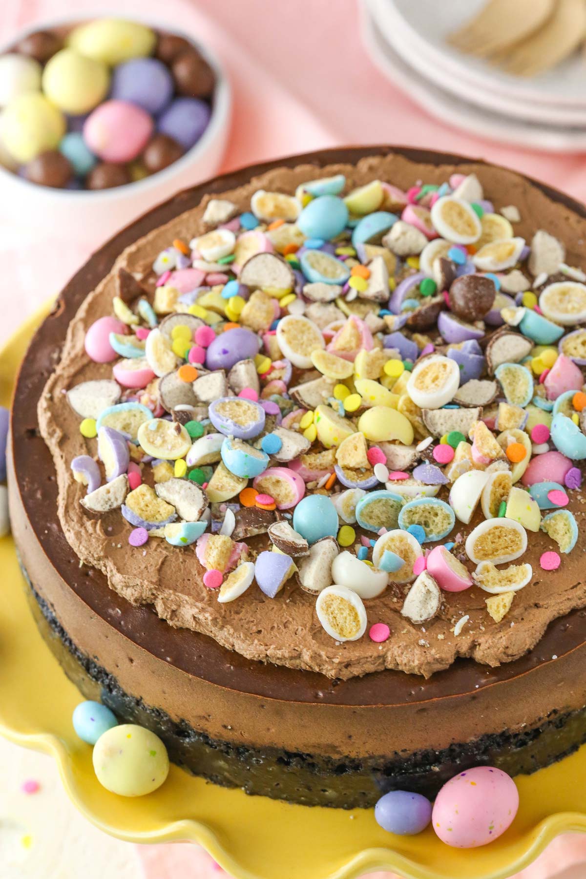 Top view of a fully decorated malted Easter egg chocolate cheesecake.