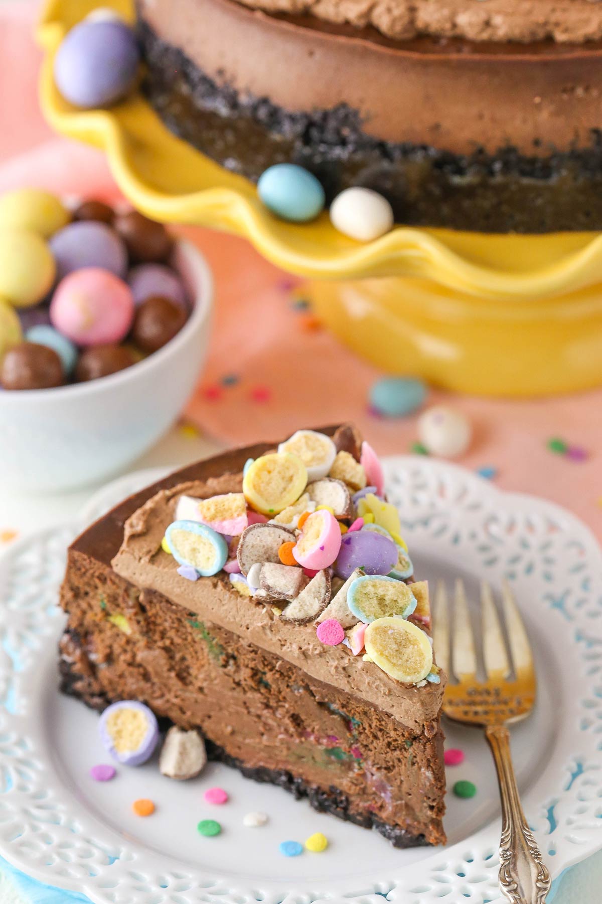 A slice of malted Easter egg chocolate cheesecake on a white plate. 