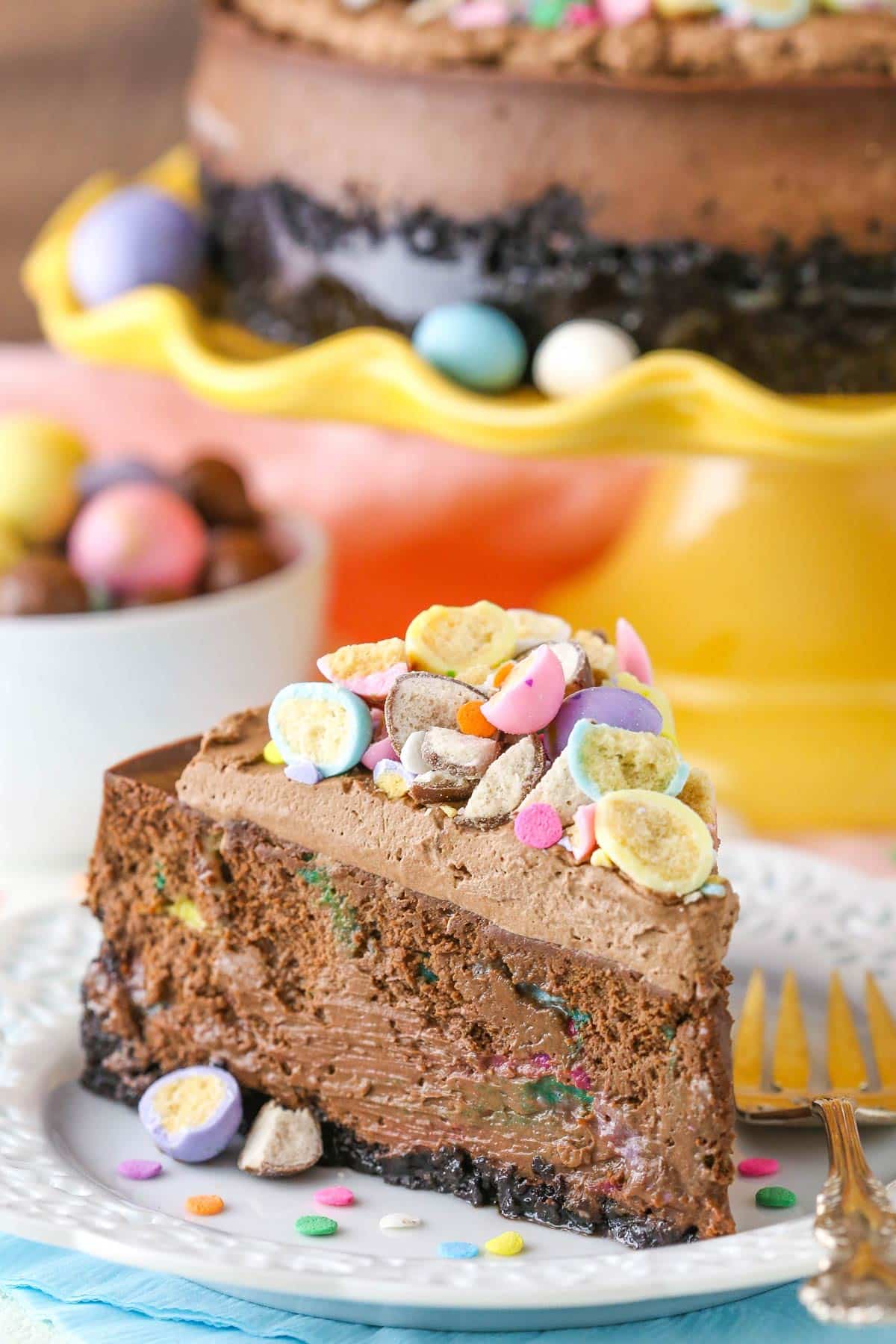 A slice of chocolate Easter cheesecake on a white dessert plate. 