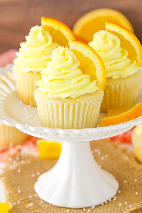 Orange Cream Cupcakes displayed on white stand