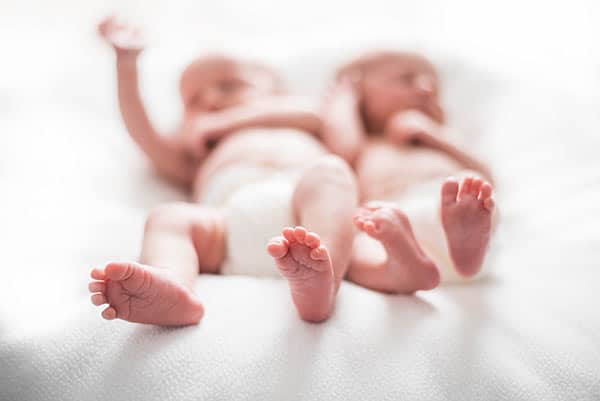 Ashton and Brooks Laying Down with their Little Feet in Focus