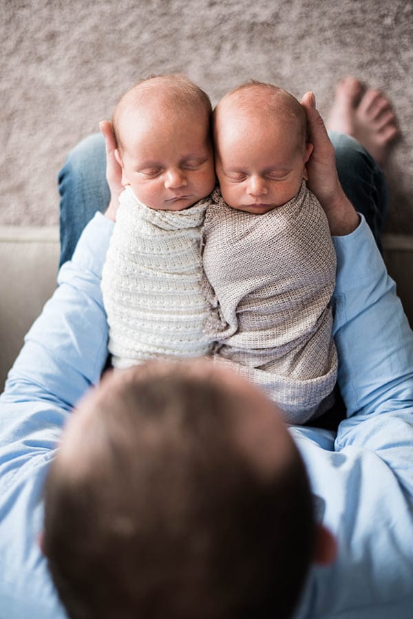 My Husband Holding Ashton and Brooks on His Lap While They're Swaddled