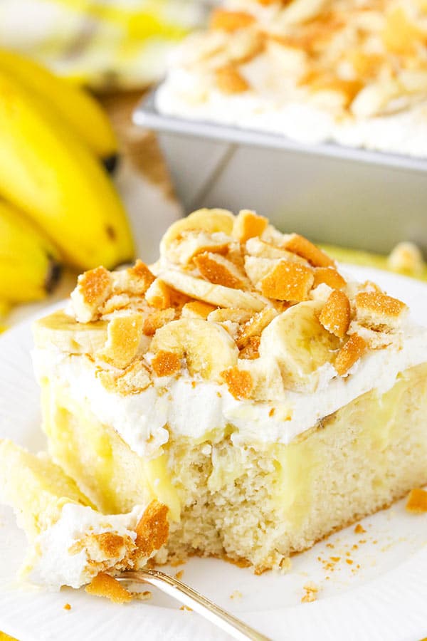 Banana Pudding Poke Cake serving with bite on fork