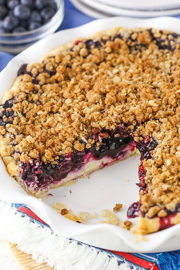 Blueberry Crumb Cheesecake Pie with slice missing.