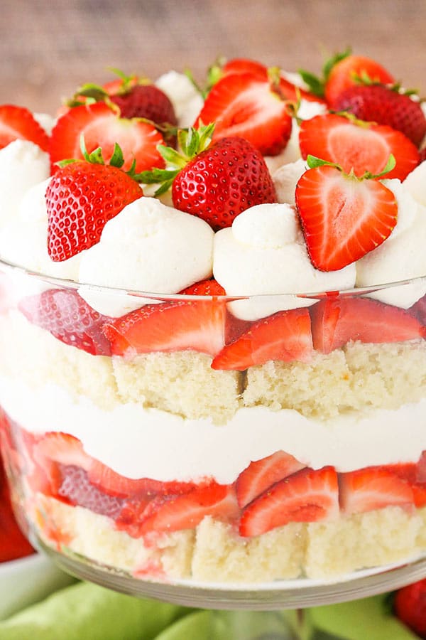 A glass bowl with strawberry trifle layers