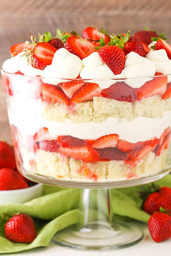 A glass bowl with strawberry trifle layers