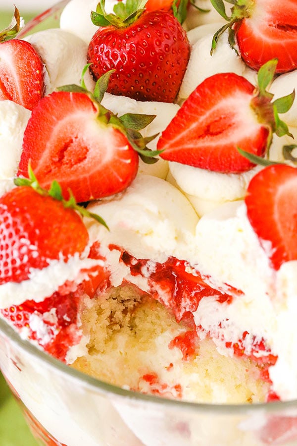 A glass bowl with strawberry trifle layers