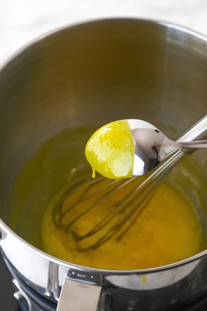 cooked lemon curd coating the back of a spoon