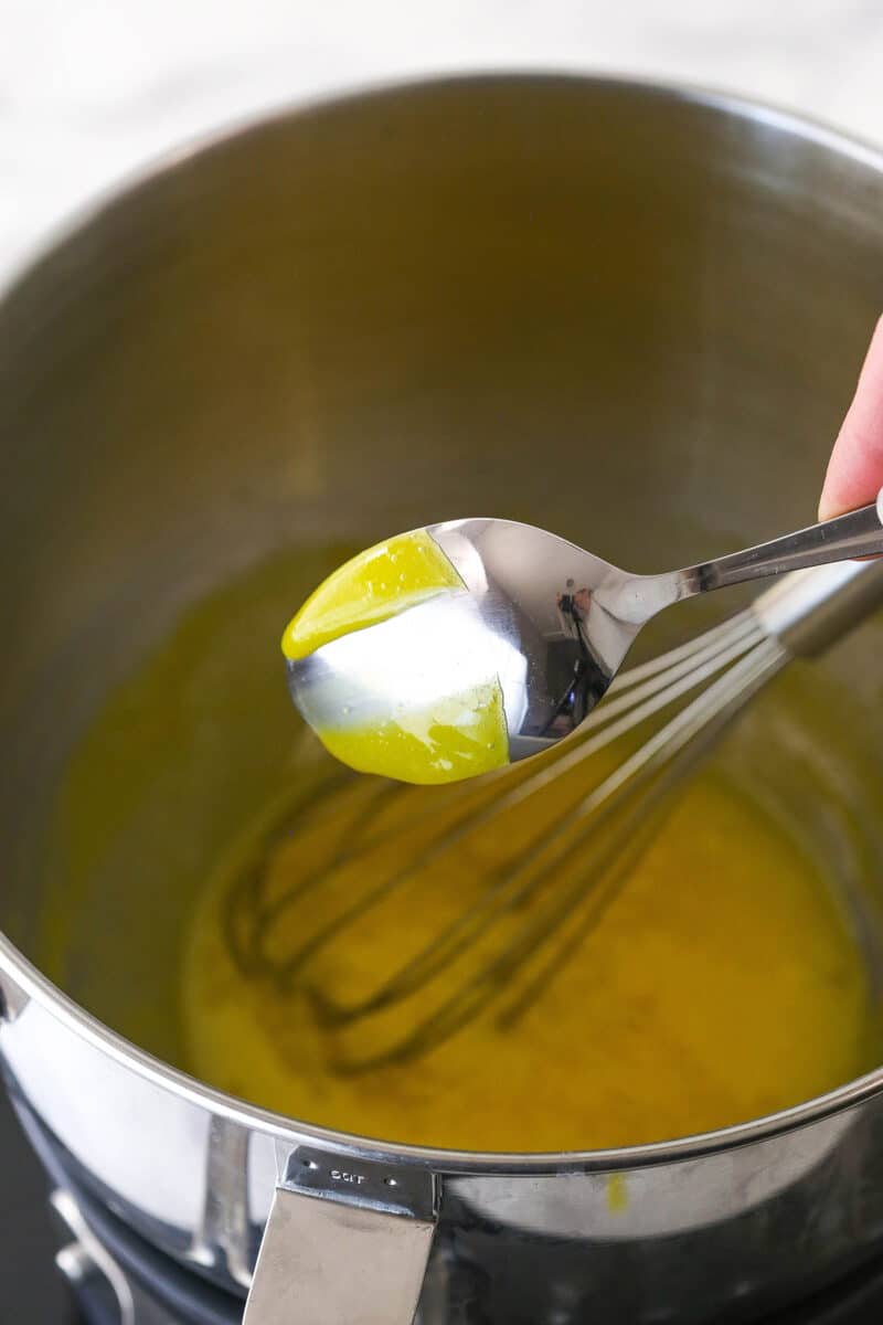 cooked lemon curd on back of spoon with a line through it to show thickness