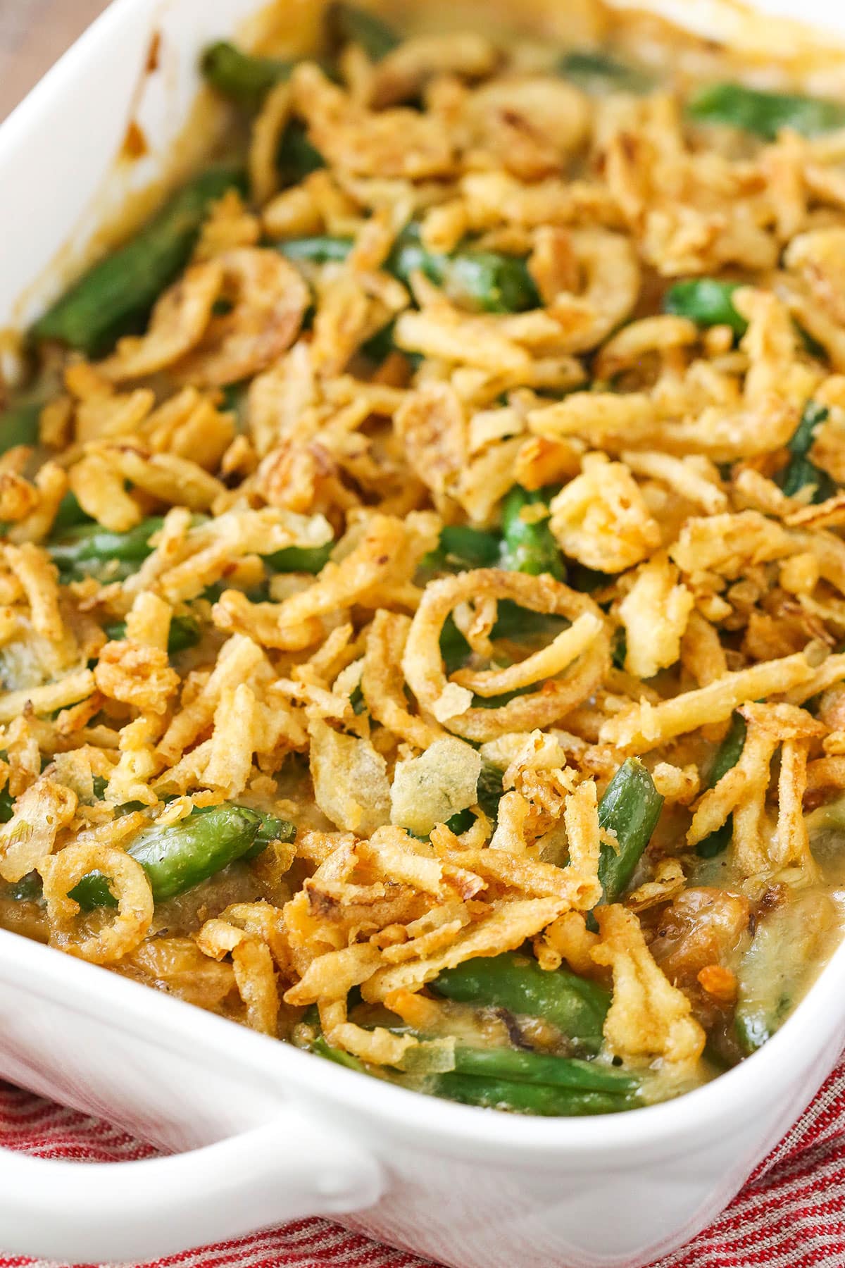 A green bean casserole covered with crispy fried onions.