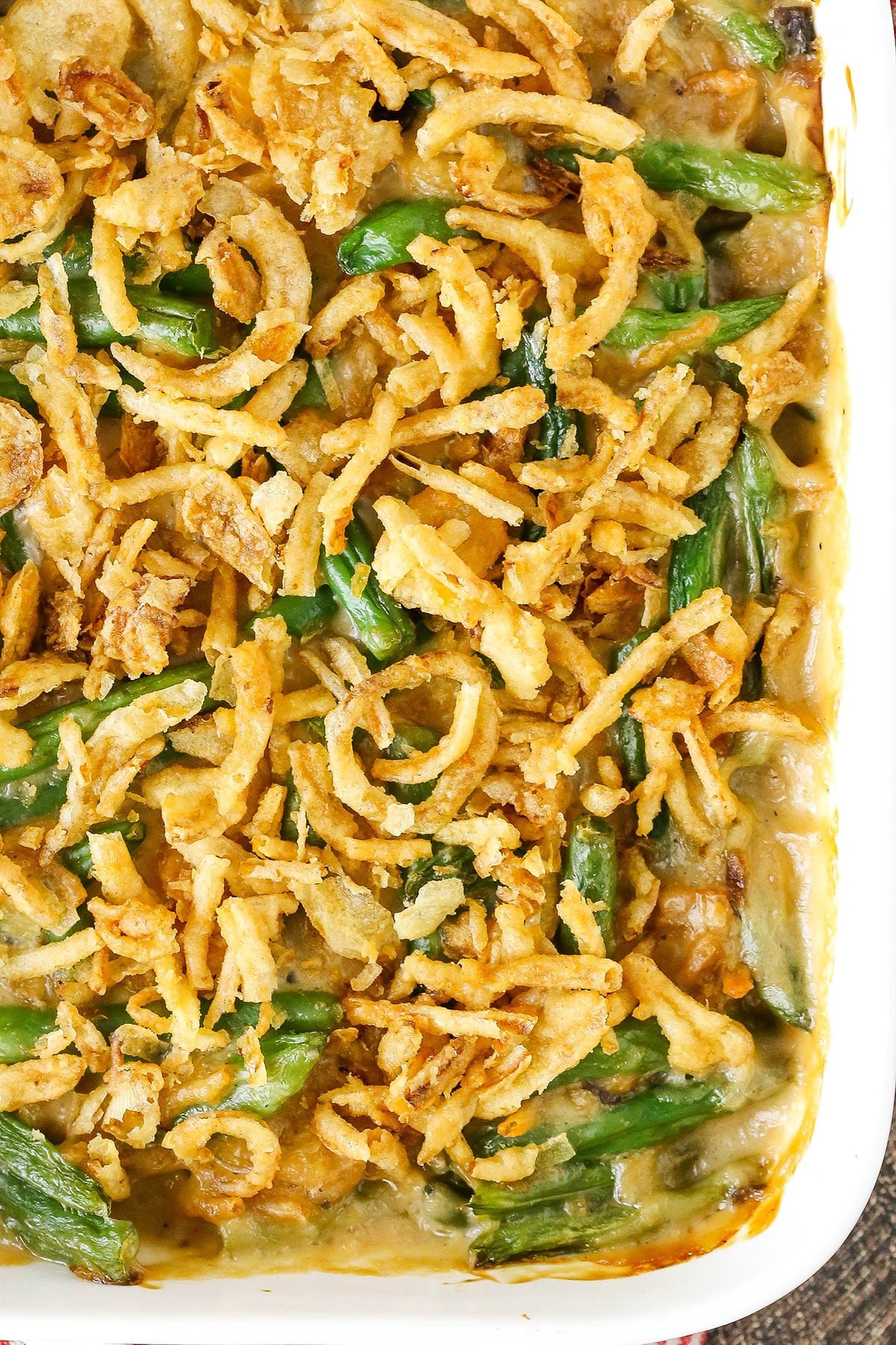 Overhead view of green bean casserole in a white ceramic casserole dish