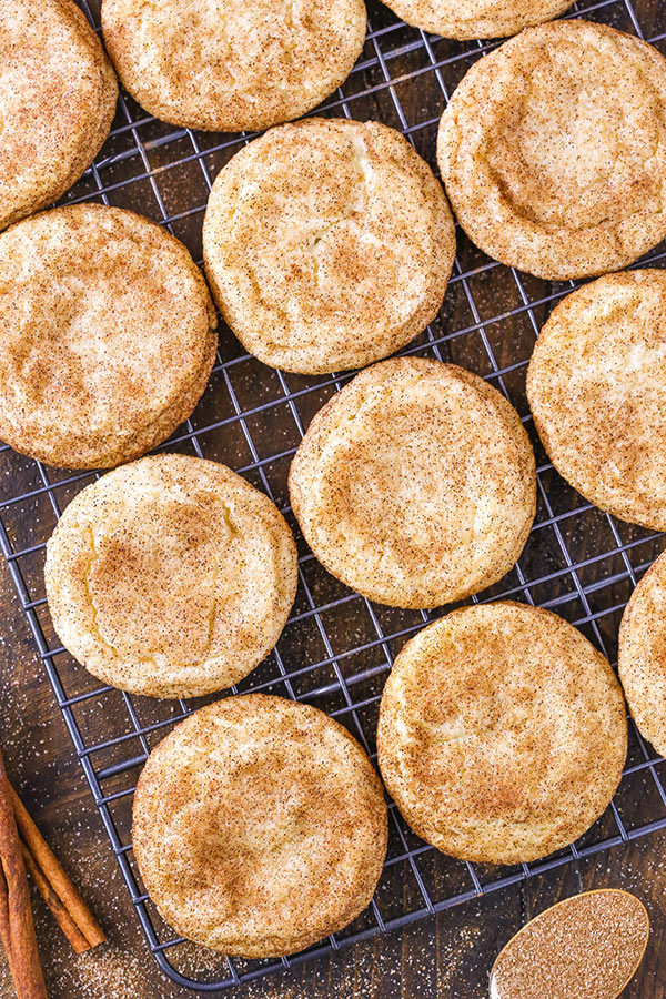 A wire cooling rack holding neatly arranged snickerdoodle cookies