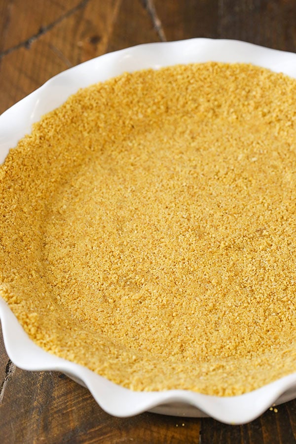 This graham cracker crust is easy to make and delicious, made with scratch from only four ingredients! It won't fall apart and it's perfect for baked pies, no bake pies and cheesecakes!