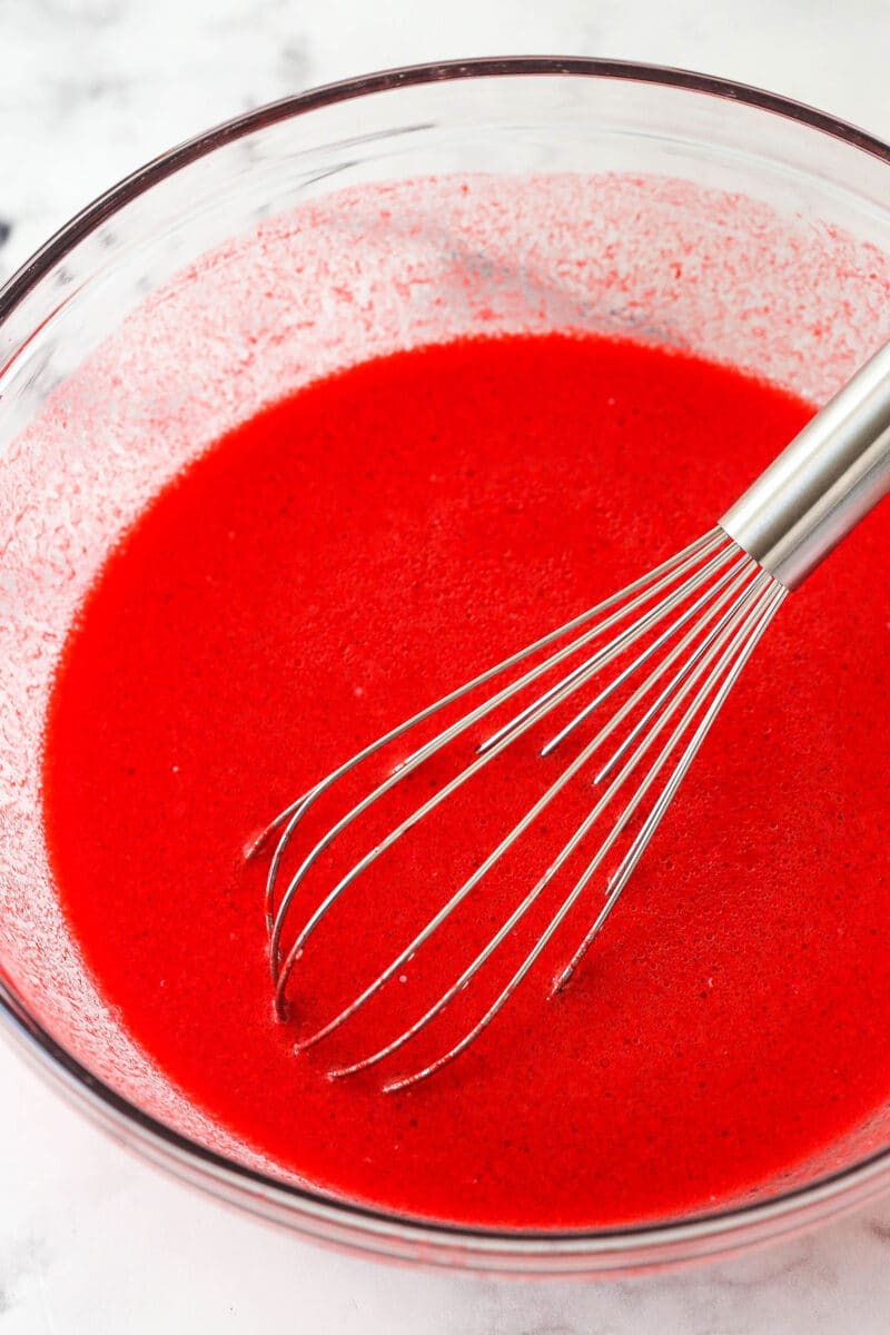 wet ingredient for red velvet cake combined in glass bowl