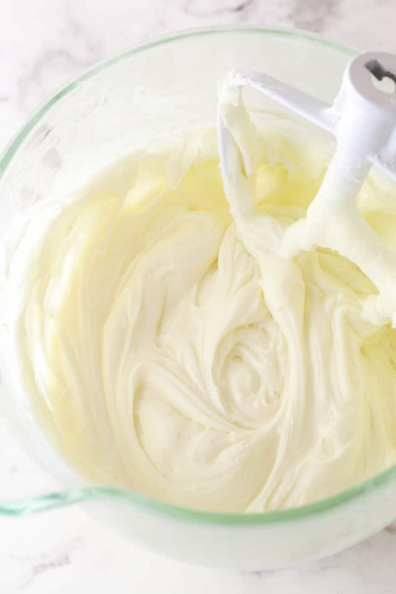cream cheese frosting mixed together in glass mixing bowl