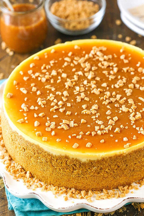 Close up of homemade cheesecake topped with salted caramel and toffee bits