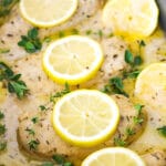 Cooked Chicken Breasts in a Slow Cooker with Sauce, Herbs and Lemon Slices