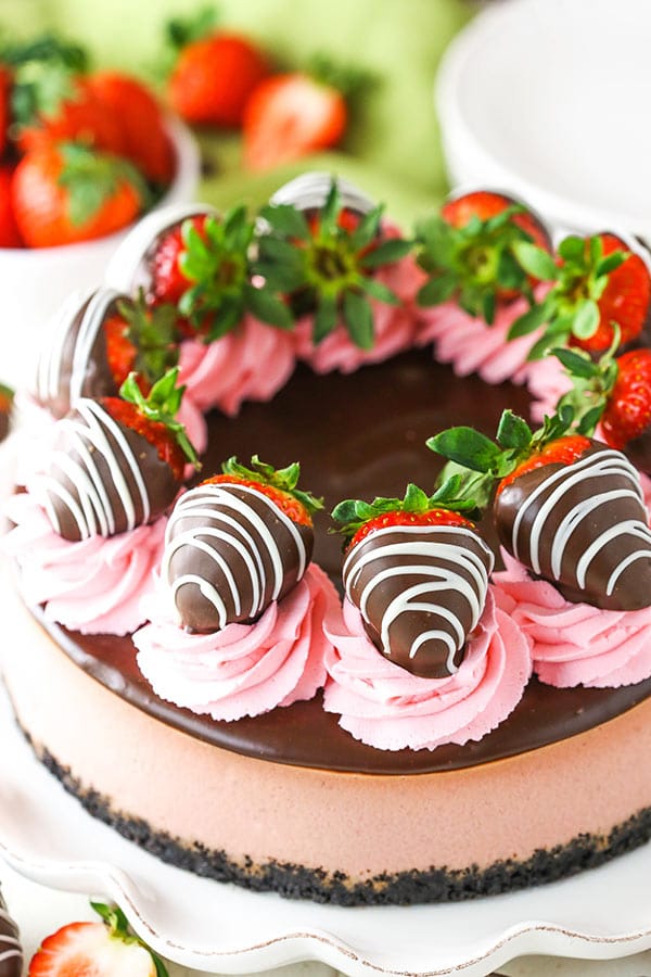 This Chocolate Covered Strawberry Cheesecake is made with a strawberry cheesecake filling and chocolate Oreo crust, all covered in chocolate ganache and chocolate covered strawberries!