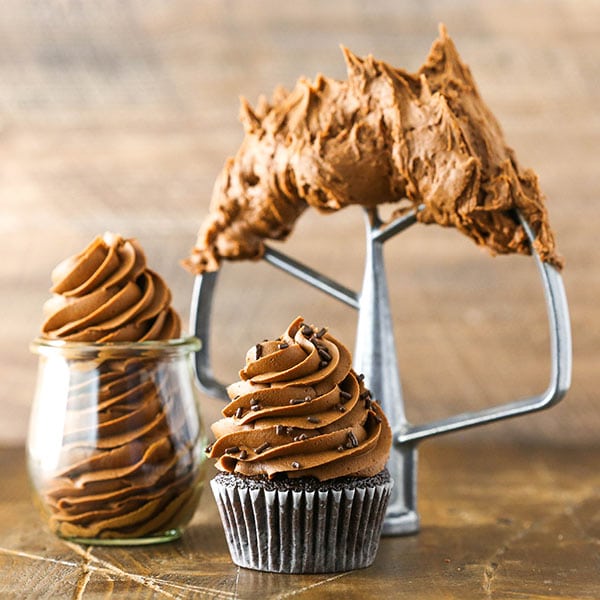 Fudgy Chocolate Buttercream Frosting on mixer paddle, in jar and on cupcake