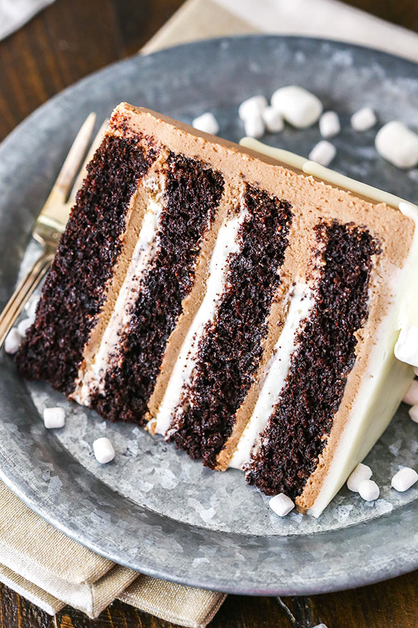 This Hot Chocolate Cake is a moist chocolate cake, hot chocolate buttercream frosting and marshmallow filling!