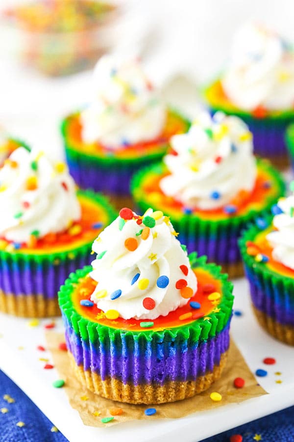 These Mini Rainbow Cheesecakes are so fun with colorful swirl layers - perfect for St. Patricks Day or a kid's party! They are also thick, creamy and delicious!
