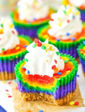 Mini Rainbow Cheesecakes with bite taken out