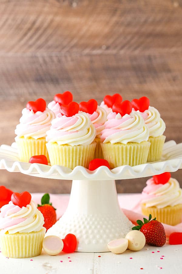 These Strawberry Truffle Cupcakes are moist vanilla cupcakes filled with strawberry truffle filling, topped with white chocolate buttercream!