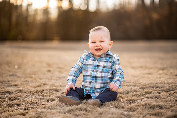 brooks sitting on the ground and smiling