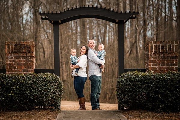 all four of us under a wooden arch