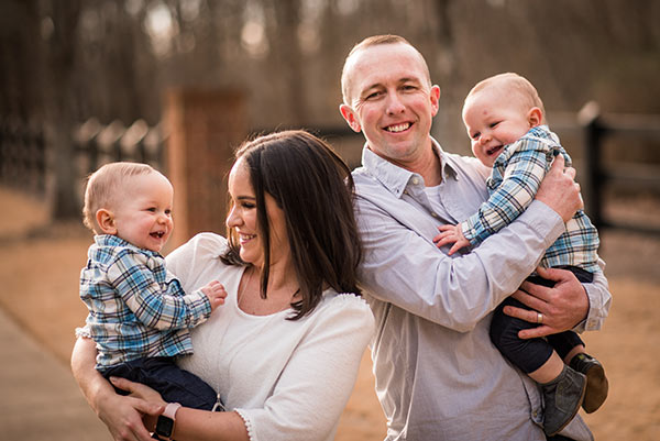 Conchar family photo, standing and holding the boys