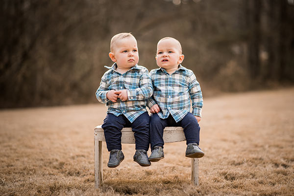 the twins sitting on a bench