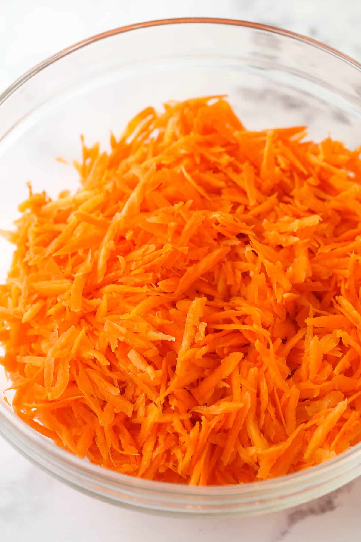 grated carrots in a clear bowl