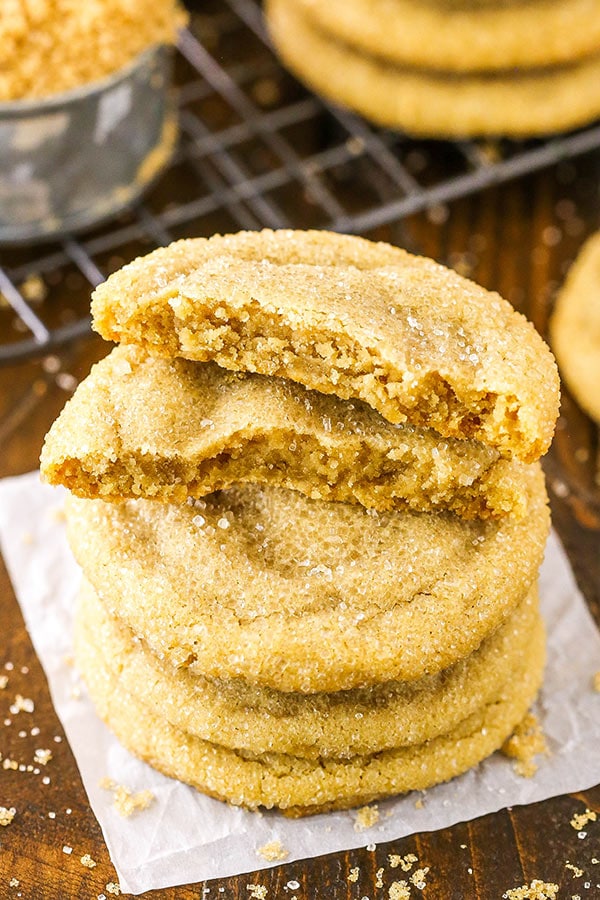 Overhead image of a stack of brown sugar cookies with the top cookie broken in half.