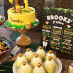 Eight Servings of Banana Pudding on a Serving Platter Next to a Banana Monkey Birthday Cake