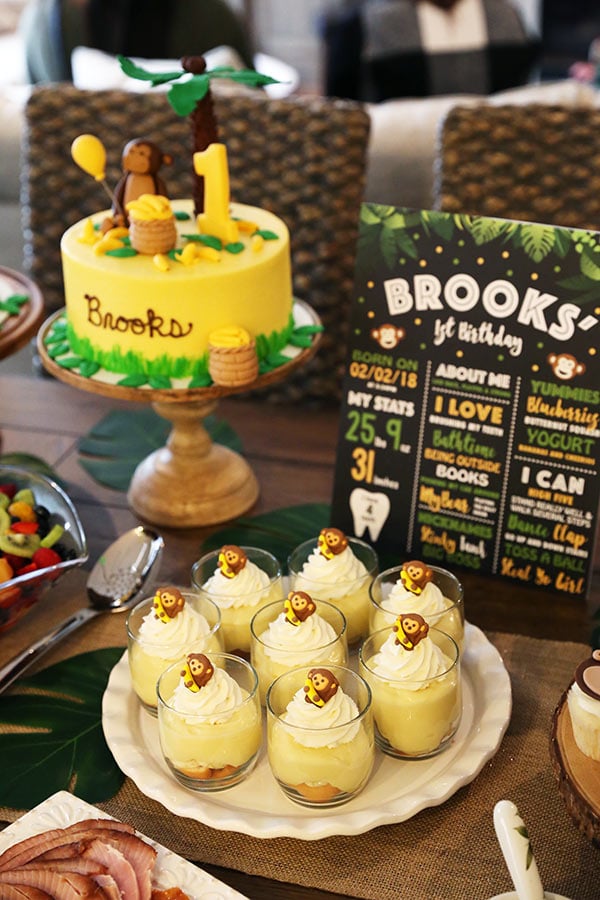 Eight Servings of Banana Pudding on a Serving Platter Next to a Banana Monkey Birthday Cake