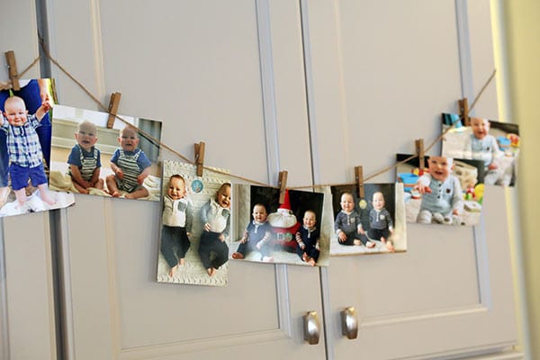 Seven Photos of the Twins Clipped onto a Little Decorative Clothesline