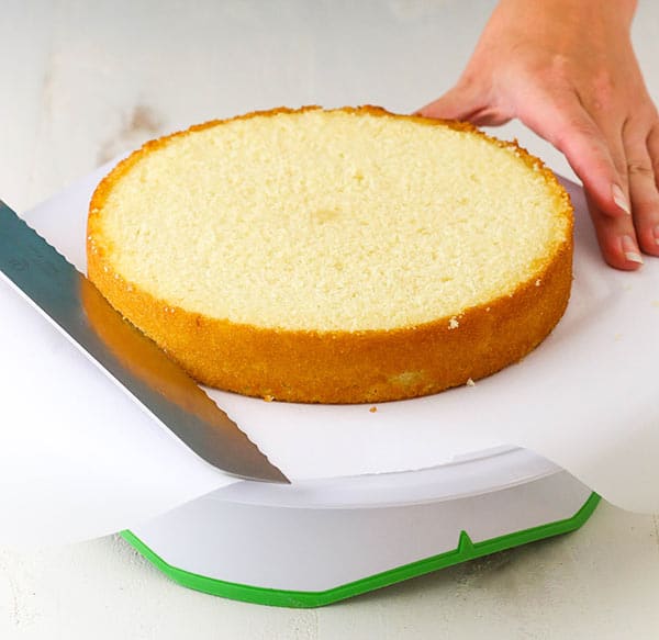 using serrated knife to slice cake in half