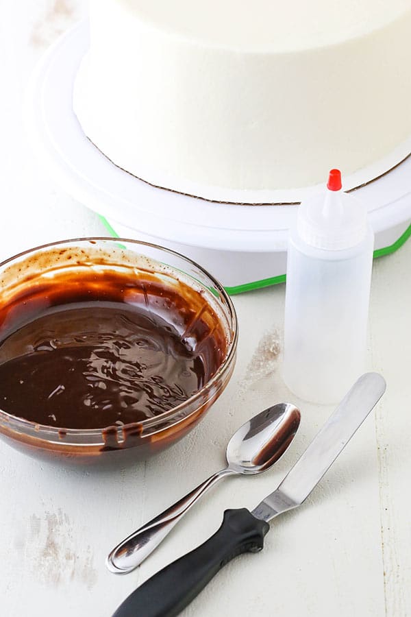 tools for decorating a chocolate drip cake