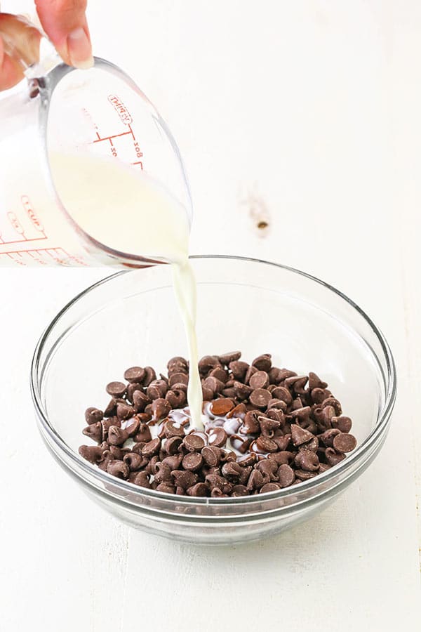 pouring hot cream into chocolate chips