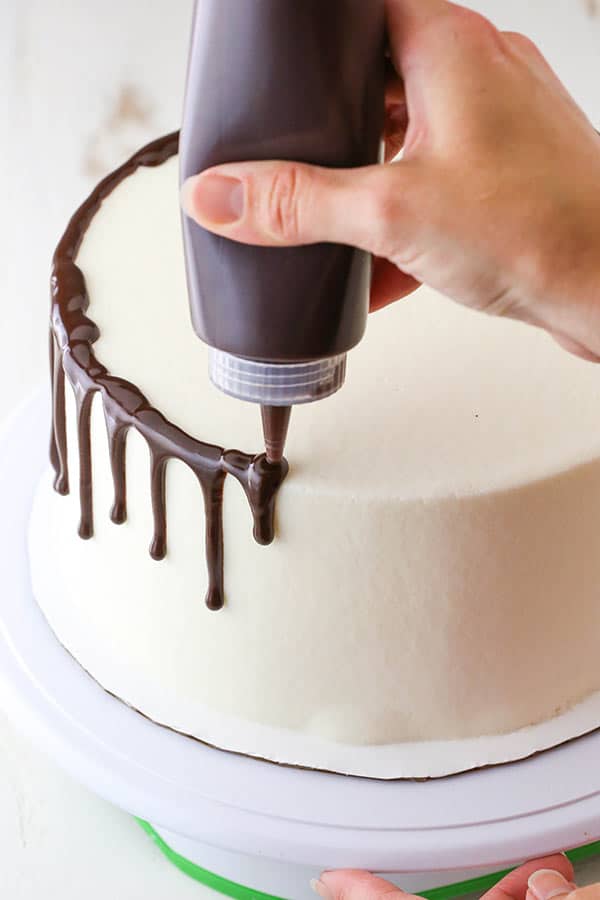 adding a chocolate drip with a squeeze bottle
