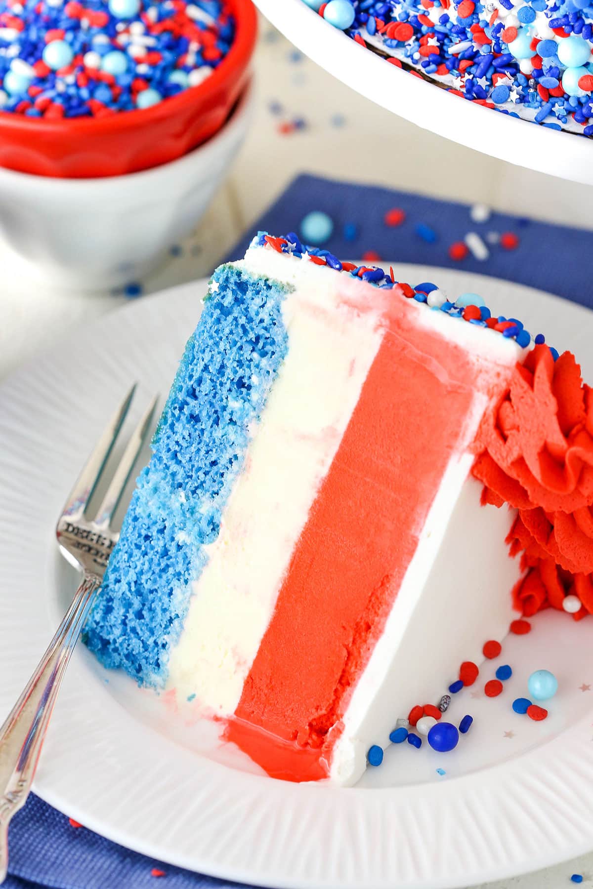 Slice of patriotic cake with red white and blue layers.