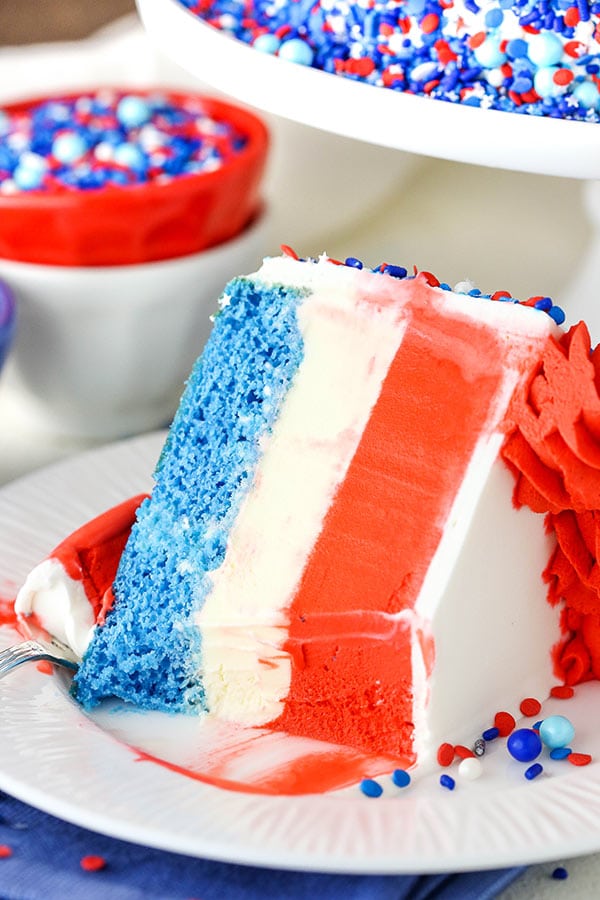 slice of red white and blue ice cream cake with a bite out