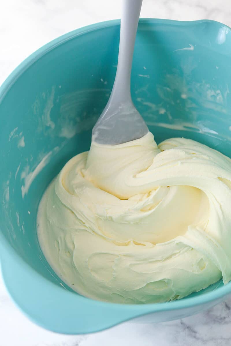 Softened vanilla ice cream in a blue bowl.